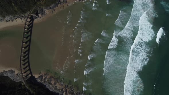 Birds eye drone shot of Wilderness beach in South Africa - drone is descending over the old railway alt