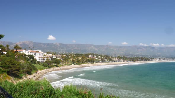 Looking off a cliff over the blue ocean and white sand beaches of Santa Barbara, California on a sun alt