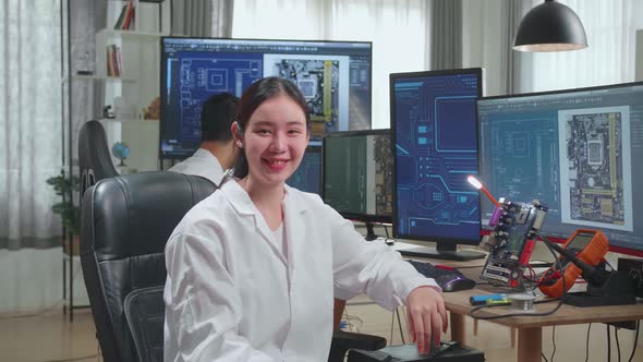 Asian Woman Smiling Charmingly Looking At Camera. Intelligent Female Scientist Working In Office alt