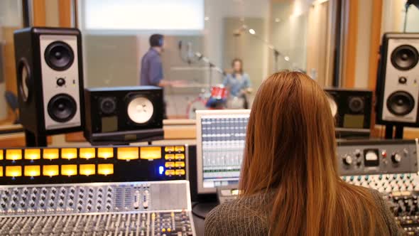 Female audio engineer using sound mixer alt