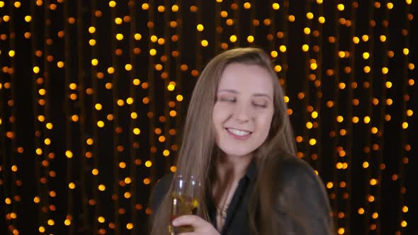 Portrait of Woman with Glass of Champagne Dancing at Party alt