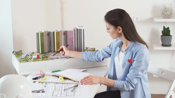 Young Professional Architect Concentreated on Working in Office. alt