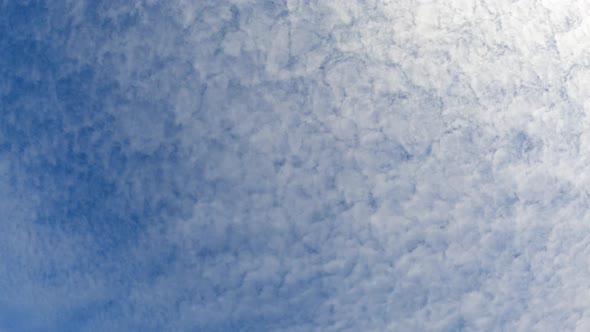 Time-lapse of clear blue sky white fluffy clouds