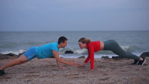 Happy Couple Doing Sports Training By the Sea