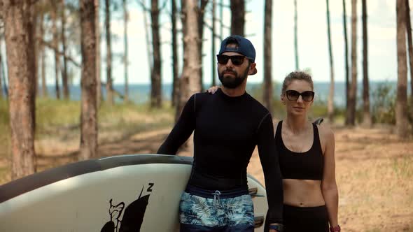 Couple After Swim Surfing Boat Fitness Workout With Oar. Travel SUP Water Tourism Holiday Vacation. alt
