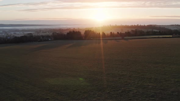 Aerial drone video of Rural English countryside and fields on a farm in beautiful British scenery in alt