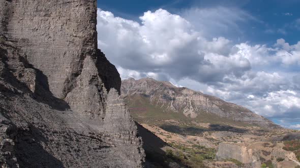 Flying towards rocky cliff face looking towards the sky alt