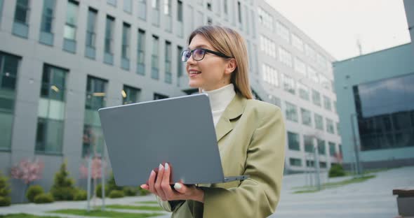 Businesswoman or Student University Working or Studying Online Using Laptop on Street alt