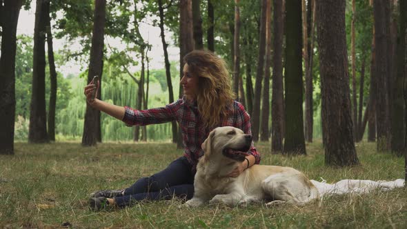 Pretty Girl Is Making Selfie with Her Labrador alt