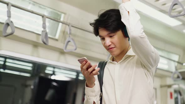 Businessman Using Mobile Phone on Public Train alt