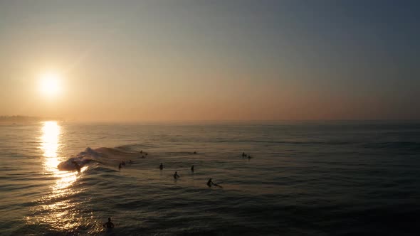 Sunrise on a Sandy Beach in the Southern Part of the Island of Sri Lanka. Surfers Ride on Their