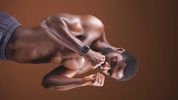 Athletic Man with Good Abs on an Isolated Dark Background alt