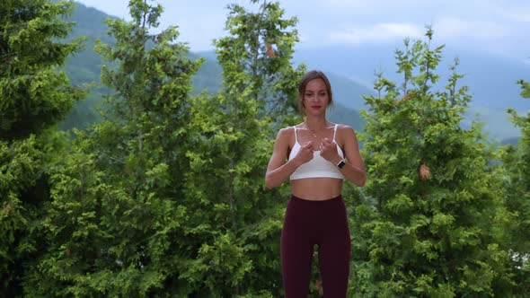 Fit Woman Doing Wrist Warmup Exercise