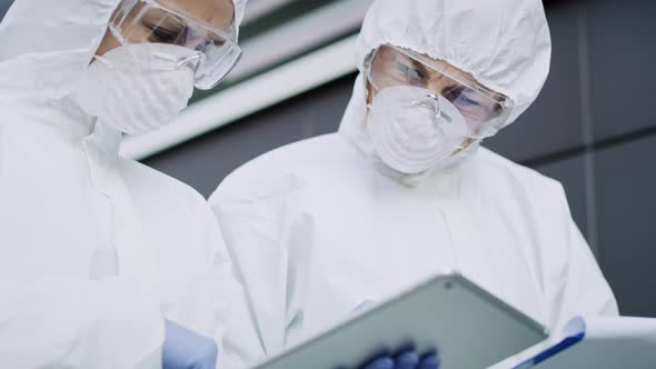 Video of walking technicians in clean suit. Shot with RED helium camera in 8K. alt