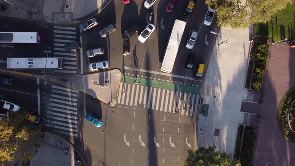 top aerial view of pedestrians passing safely on the crosswalk on a busy avenue in buenos aires city alt