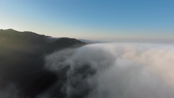 Aerial view of thick clouds over the canyon at sunrise in Malibu Canyon, Monte Nido, California, USA alt