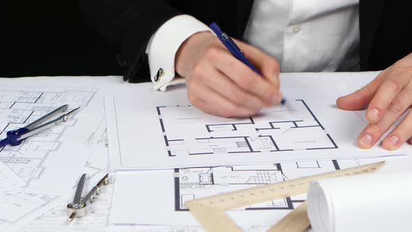 Businessman Looks at the Original Data for the Drawing. Close Up alt