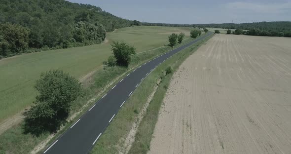 Aerial Lowering Drone Shot of a Rural Road Revieling the Beautiful View