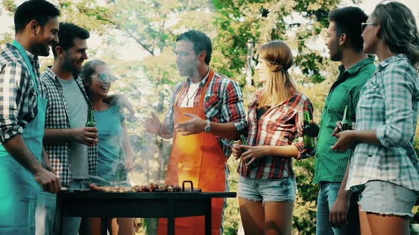 Young People Grilling Outdoors