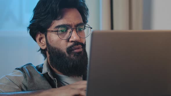 Closeup Pensive Busy Bearded Arabian Hispanic Indian 35s Man Looking at Laptop Screen Reading News alt