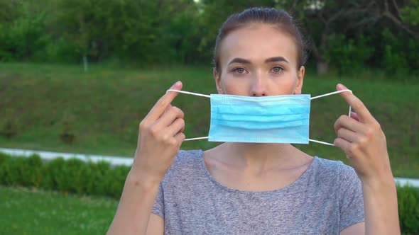 Portrait of a Young Student Woman Wearing Protective Mask on Street.