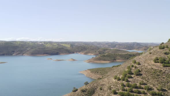 Aerial drone view of Barragem de Odeleite Dam reservoir in Alentejo, Portugal alt