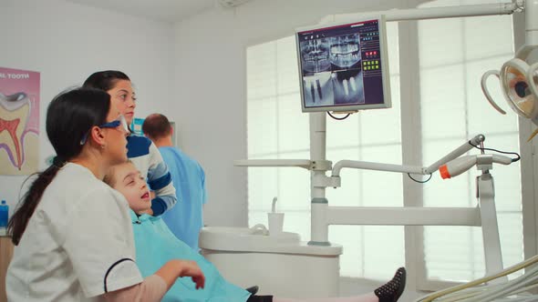 Pediatric Dentist Showing on Monitor Teeth Xray alt