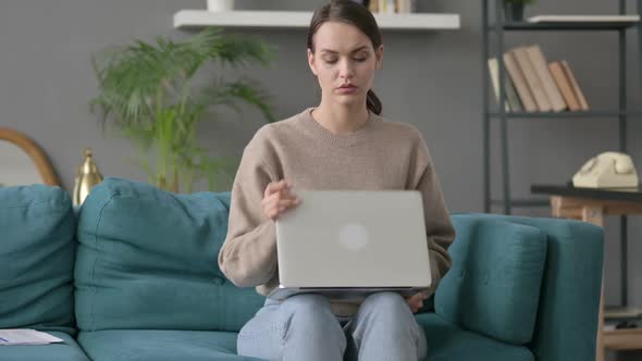 Woman Closing Laptop Leaving Sofa alt