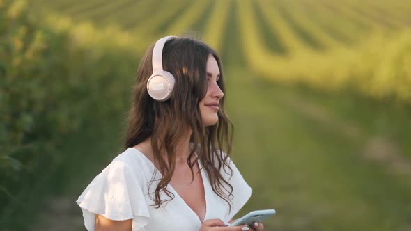 close-up portrait of a young woman listening to music on headphones and relaxing alt