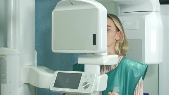 Female Patient Undergoing Tests on Dental X-Ray Scanner