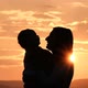 Young Happy Mom Gently Kisses Her Little Baby at Sunset - VideoHive Item for Sale