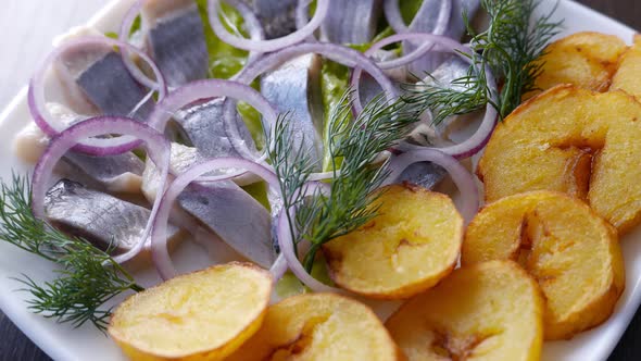Herring Fish Served with Potatoes and Onion on White Plate