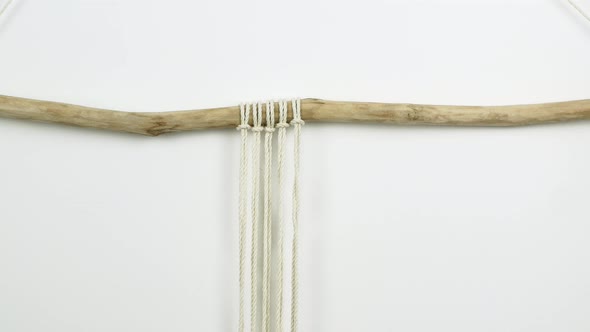 Macrame A woman makes home decor in Boho style. Woman making handmade decor weaves macrame alt