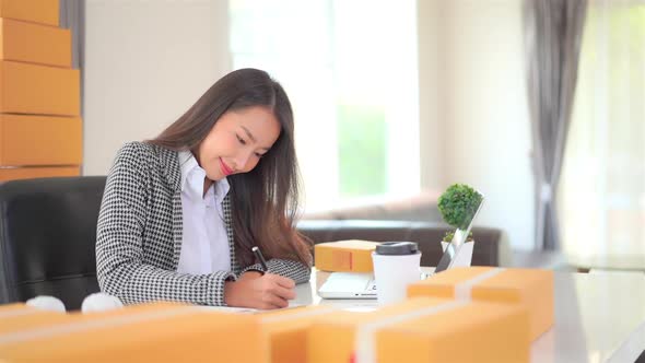 Woman with packing box ready for shipping alt