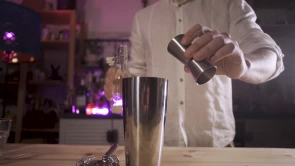 The Bartender Pouring Sugar Syrup From a Jigger Into a Shaker