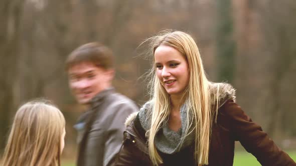 Parents playing with daughter in nature alt