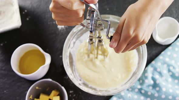 Woman whisking batter in a bowl 4k alt