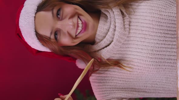 Vertical Shot Cute Girl Singing Using Wooden Spatula Instead of Microphone on Xmas Decoration