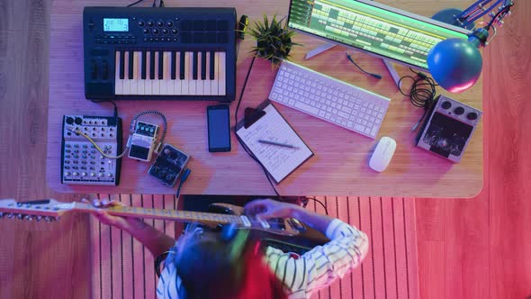 Zoomin Time Lapse of Female Musician Recording Instrumental Music in Illuminated Room alt