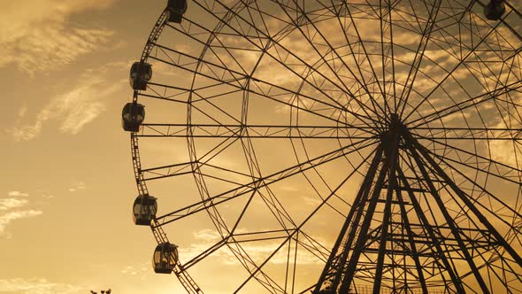 A Ferris Wheel in Park at Sunset Time. alt