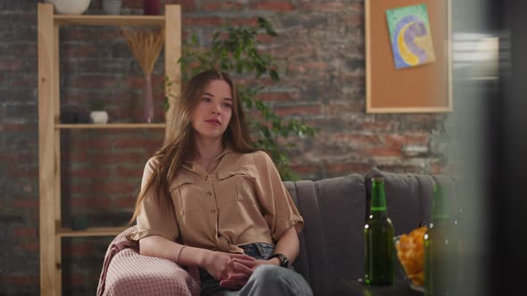 Brunette Lady Sports Fan Watches Hockey Match in Living Room alt