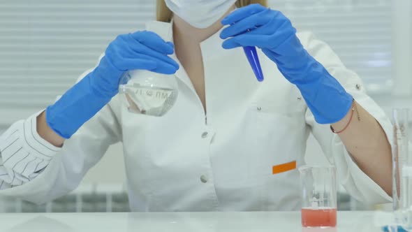 Female Scientist Analyzing Liquid In Test Tube.