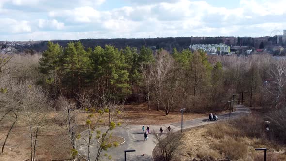 Aerial city park with walking people in spring
