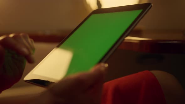 Lady Tapping Green Screen at Airplane Window alt