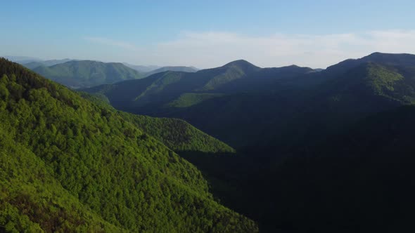 Aerial Panoramic View Over Hills with Dense Forests in Spring Carpathian Countryside