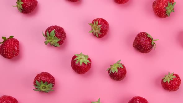 Rotating Ripe Strawberries on a Pink Background Trendy Bright Summer Background
