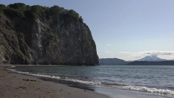 Calm Waves on Sea, Beach from Black Volcanic Sand, Rocky Shores of Pacific Ocean