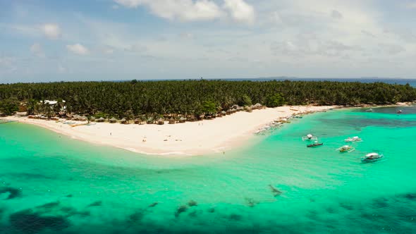 Tropical Daco Island with a Sandy Beach and Tourists alt