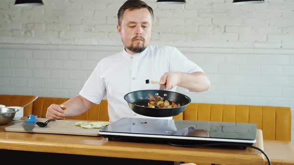 Chef Cooks Vegetables in Pan Throwing Them