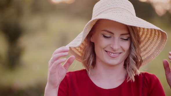 Portrait of Positive Smiling Woman Looking Into Camera at Sunset alt